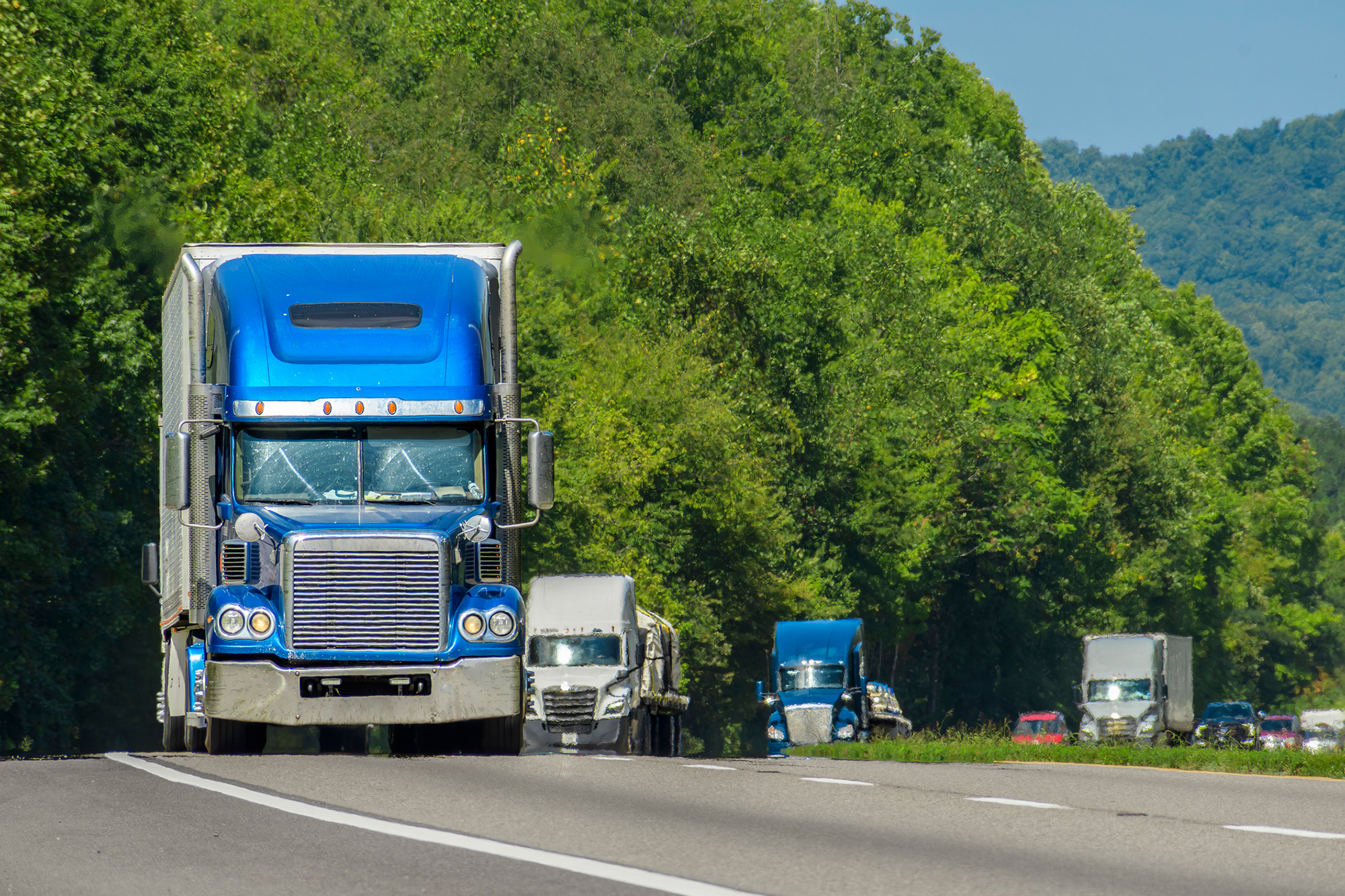 Semi trucks driving down the high way delivering freight forwarders inland freight.