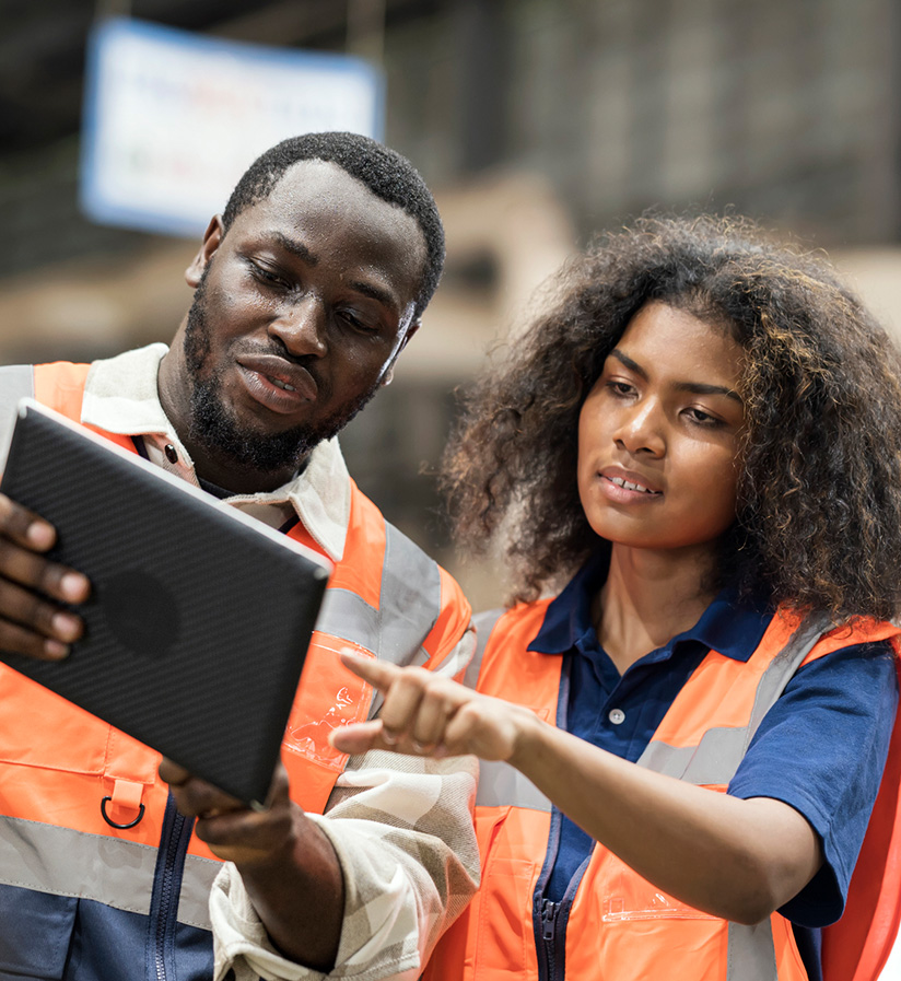 Two freight forwarders using a computer to book freight.